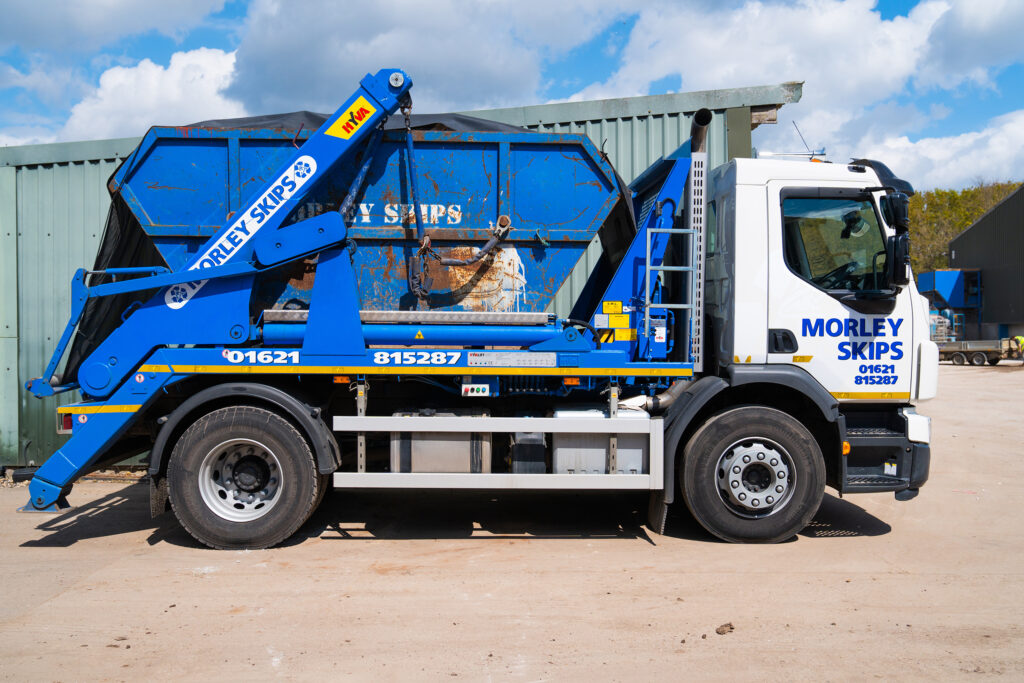 Image of Morley Skips vehicle with skip on back for blog on fly tipping