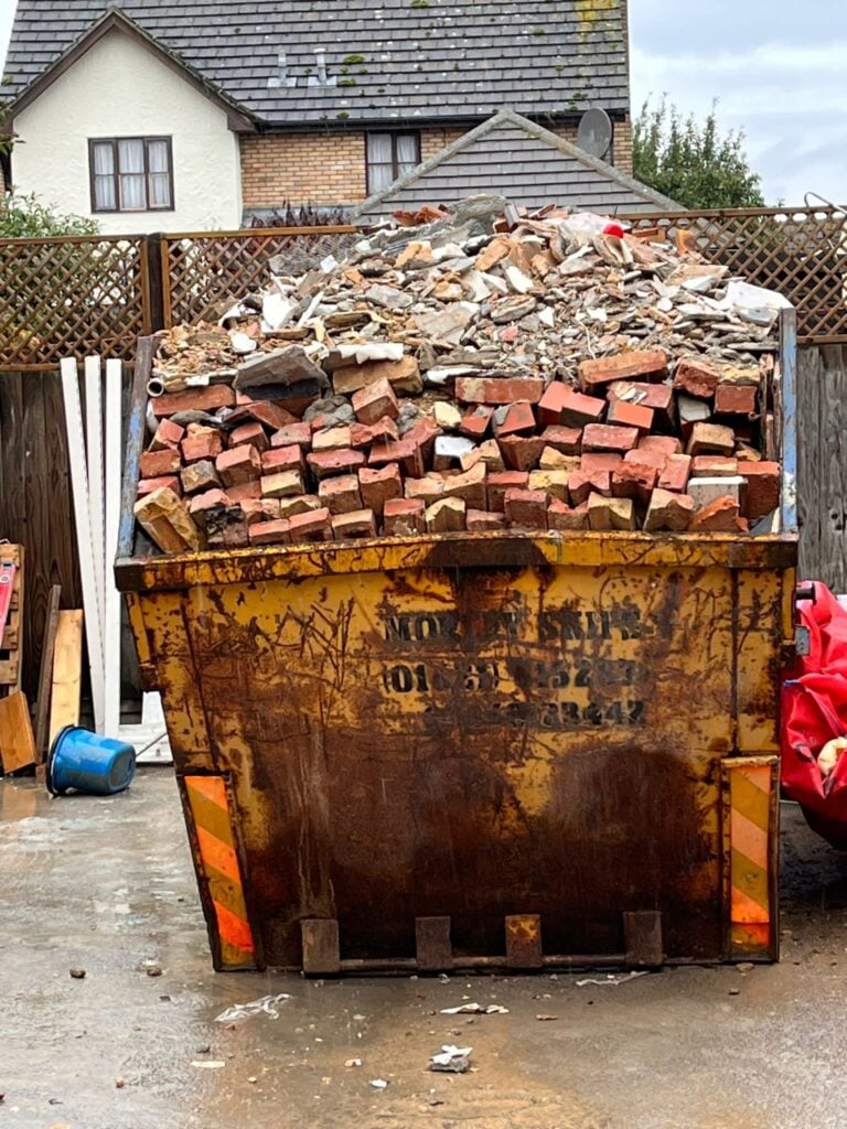 Overloaded skip with bricks